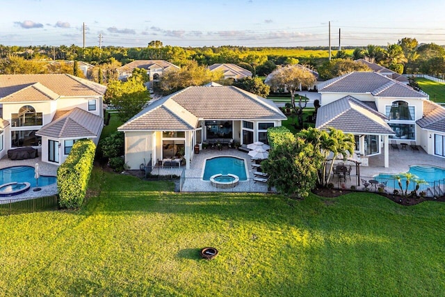 exterior space featuring fence, a lawn, and a tiled roof