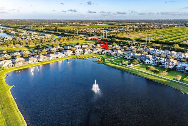 drone / aerial view featuring a water view and a residential view