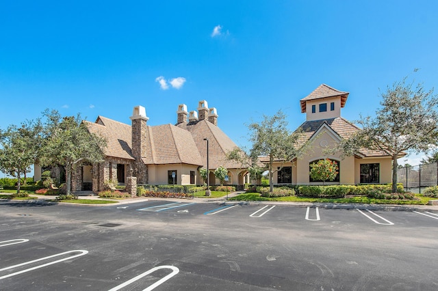 view of building exterior with uncovered parking