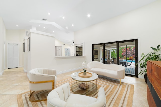 living room with light tile patterned floors, high vaulted ceiling, recessed lighting, visible vents, and baseboards