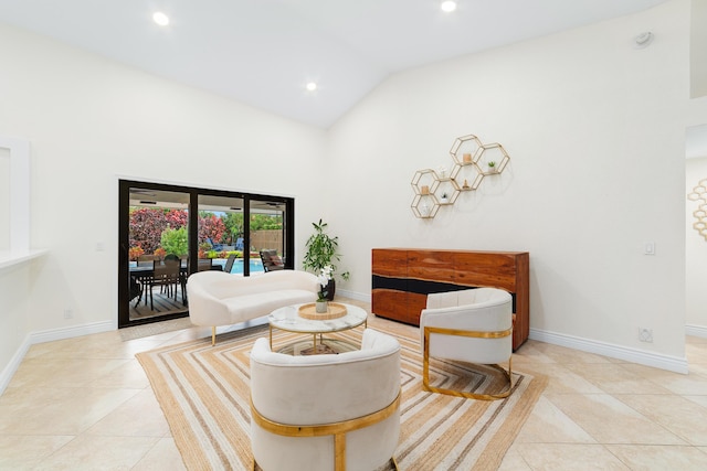 sitting room with high vaulted ceiling, recessed lighting, tile patterned flooring, and baseboards