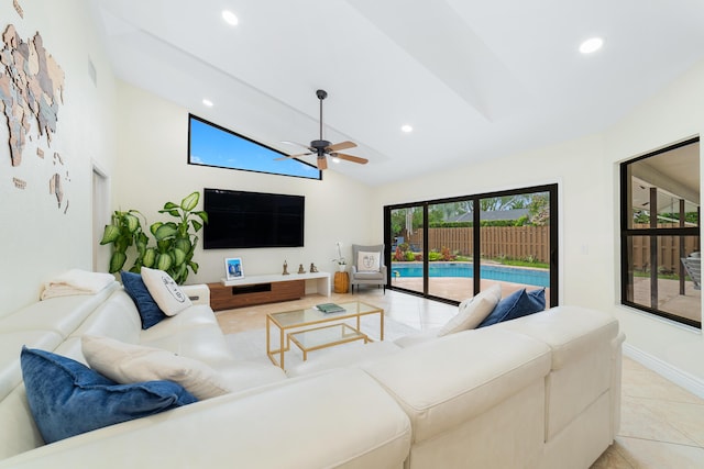 living area featuring lofted ceiling, light tile patterned flooring, recessed lighting, a ceiling fan, and baseboards