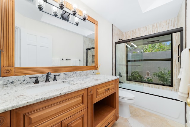 full bathroom with tile patterned flooring, vanity, toilet, and bath / shower combo with glass door