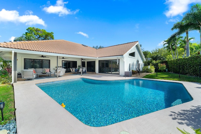 view of swimming pool featuring ceiling fan, an outdoor hangout area, fence, a fenced in pool, and a patio area