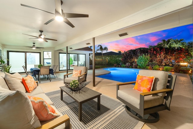 pool at dusk featuring a patio, outdoor dining area, outdoor lounge area, a ceiling fan, and a fenced in pool