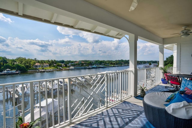 balcony featuring a water view and a ceiling fan