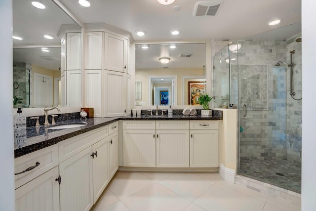 bathroom featuring a stall shower, tile patterned flooring, visible vents, and vanity