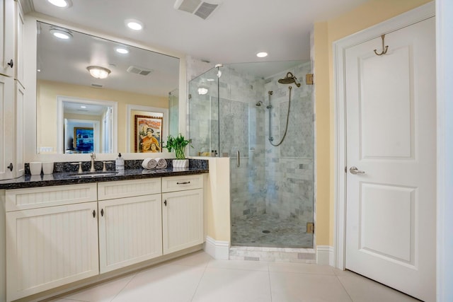 bathroom featuring a stall shower, visible vents, and vanity