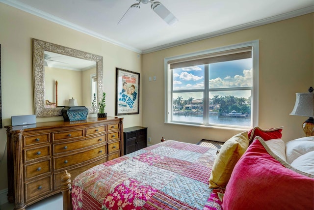 bedroom with a water view, crown molding, and ceiling fan