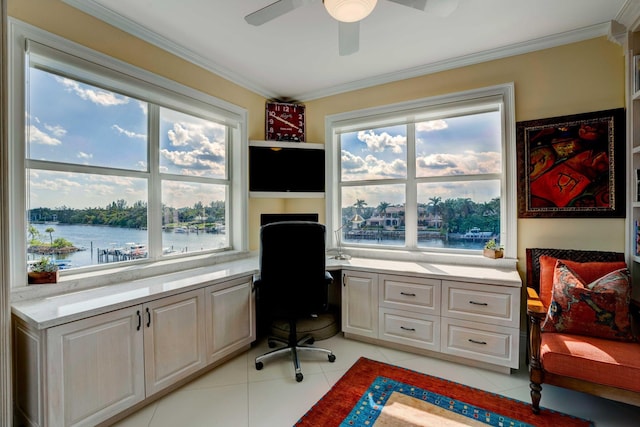 office with ornamental molding, a ceiling fan, built in desk, and light tile patterned floors