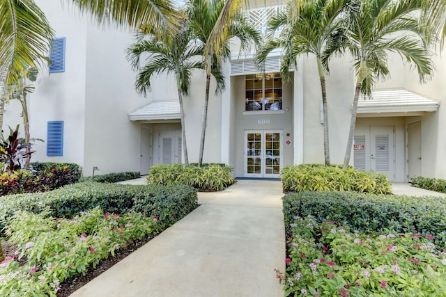 doorway to property featuring french doors and stucco siding