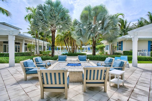 view of patio / terrace featuring a pergola and an outdoor living space with a fire pit