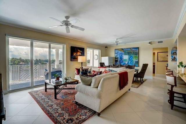 living area with crown molding, plenty of natural light, and light tile patterned floors