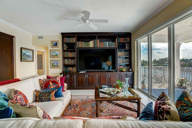 living area featuring light tile patterned floors, visible vents, a ceiling fan, and crown molding