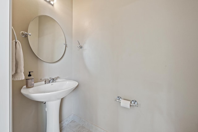 bathroom with baseboards and tile patterned floors