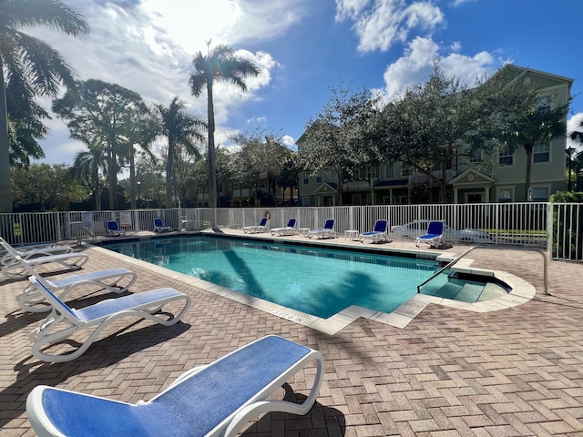 community pool featuring a patio area and fence