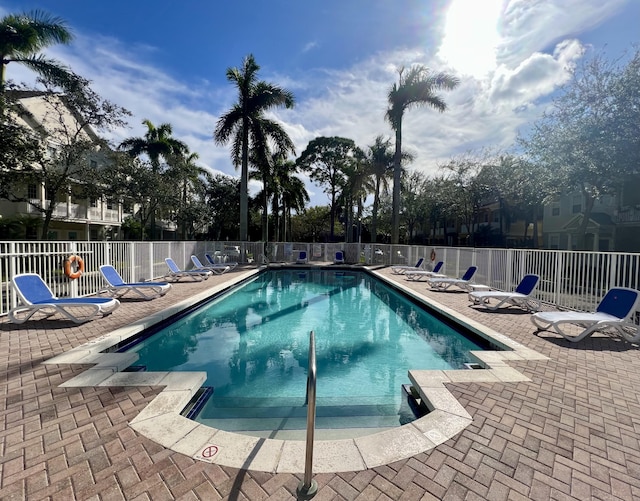 community pool featuring a patio and fence