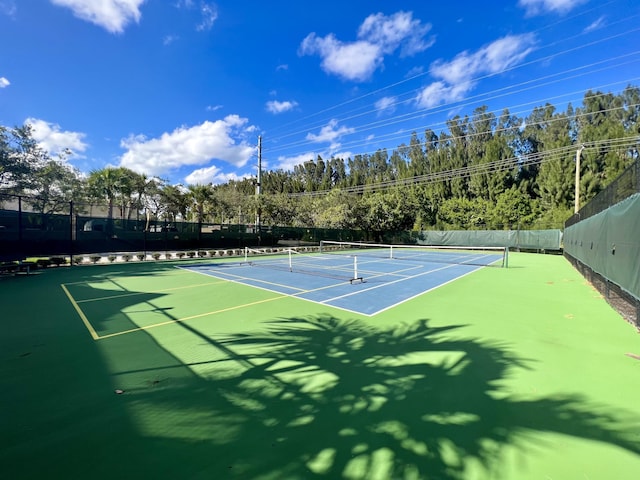 view of sport court featuring fence