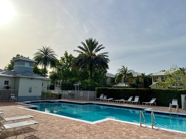 community pool featuring a patio area and fence