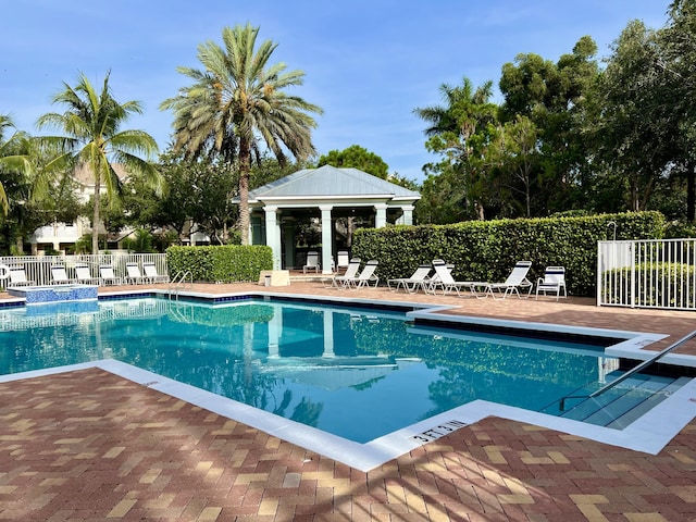 pool featuring a gazebo, a patio area, and fence