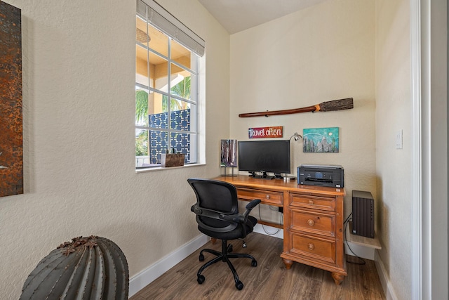 office space featuring baseboards, wood finished floors, and a textured wall