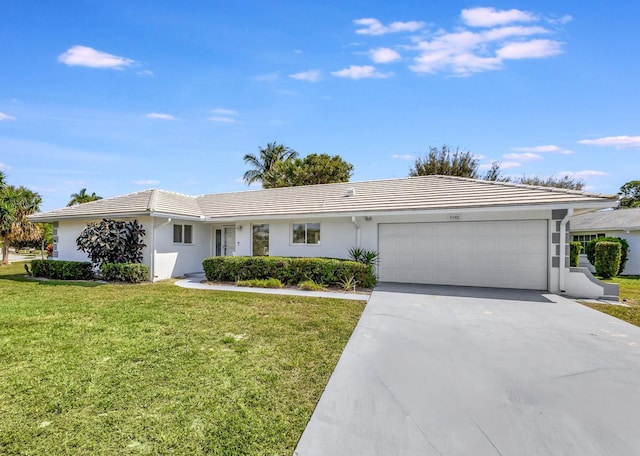 ranch-style home with a garage, a tiled roof, concrete driveway, and a front yard