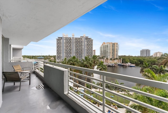 balcony featuring a view of city and a water view