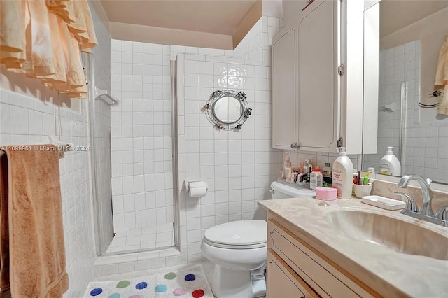 full bath with a stall shower, vanity, and tile walls