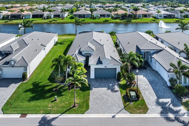 bird's eye view with a water view and a residential view