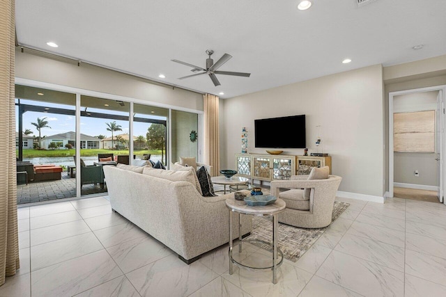 living area with a ceiling fan, recessed lighting, marble finish floor, and baseboards