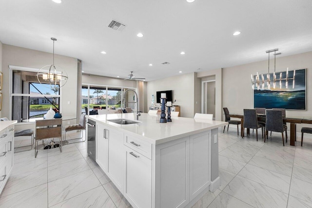 kitchen with recessed lighting, a sink, visible vents, marble finish floor, and light countertops