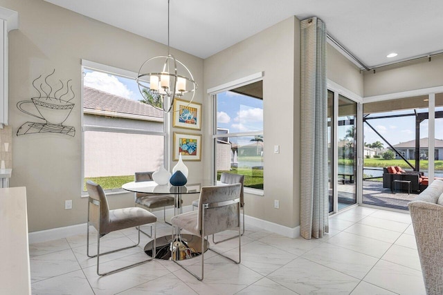 dining space with an inviting chandelier, marble finish floor, and a wealth of natural light