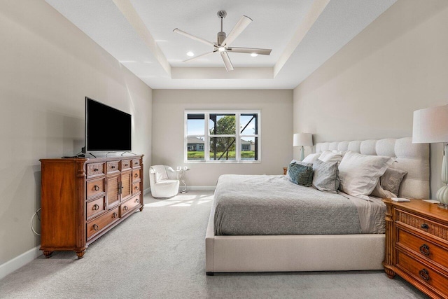 bedroom featuring a tray ceiling, light colored carpet, baseboards, and recessed lighting