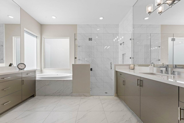 bathroom with a stall shower, marble finish floor, vanity, a bath, and recessed lighting