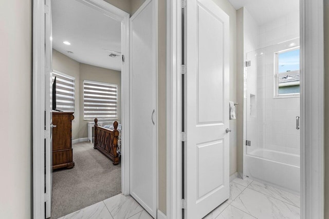 corridor with marble finish floor, visible vents, and baseboards