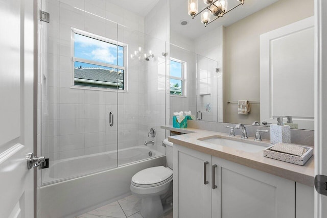 bathroom with marble finish floor, shower / bath combination with glass door, vanity, and toilet