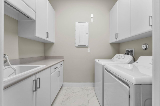 clothes washing area featuring marble finish floor, cabinet space, washing machine and dryer, a sink, and baseboards