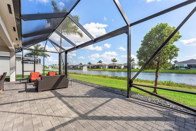 view of patio / terrace featuring a water view and a lanai