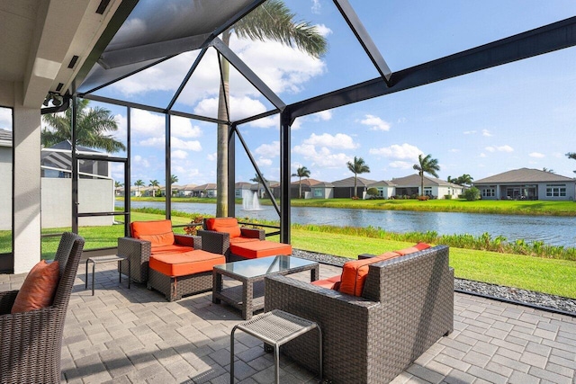 view of patio with glass enclosure, a water view, and an outdoor hangout area