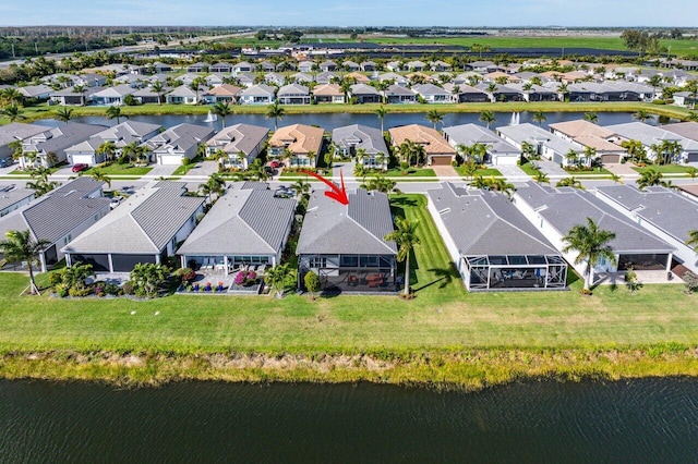 birds eye view of property featuring a residential view and a water view