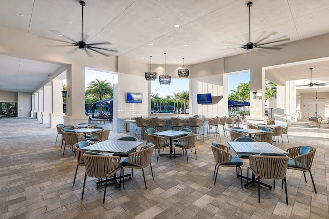 interior space with ceiling fan, brick floor, and recessed lighting