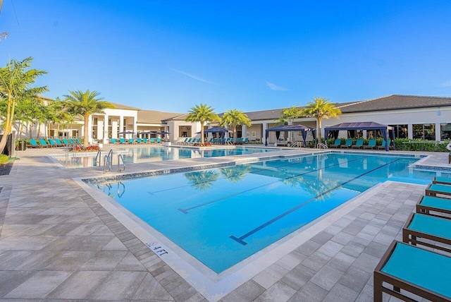 pool with a patio area and a gazebo