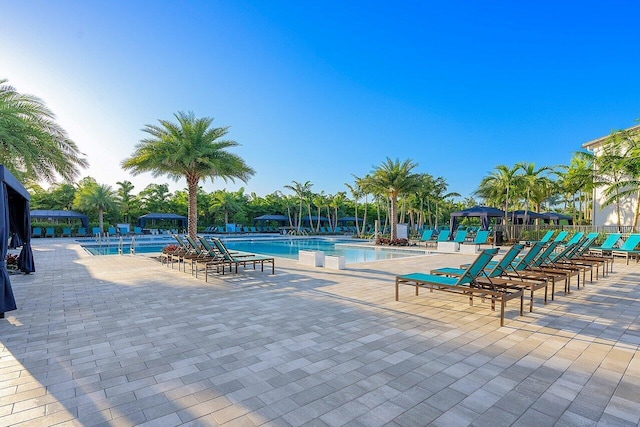 community pool featuring a gazebo and a patio