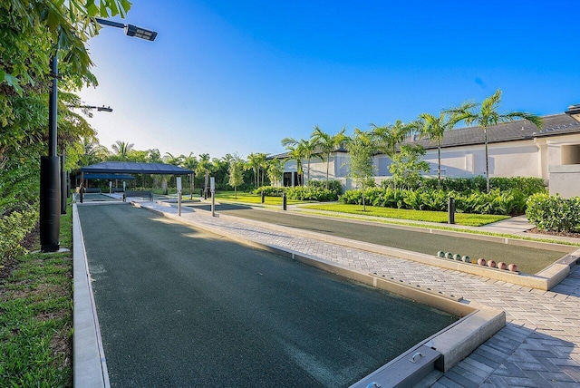 view of street featuring street lighting and curbs