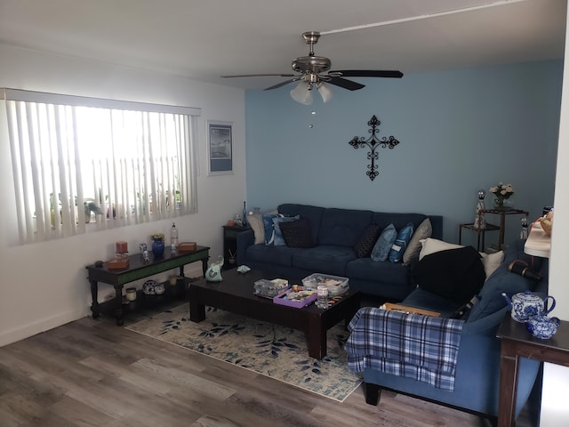 living area with wood finished floors and a ceiling fan