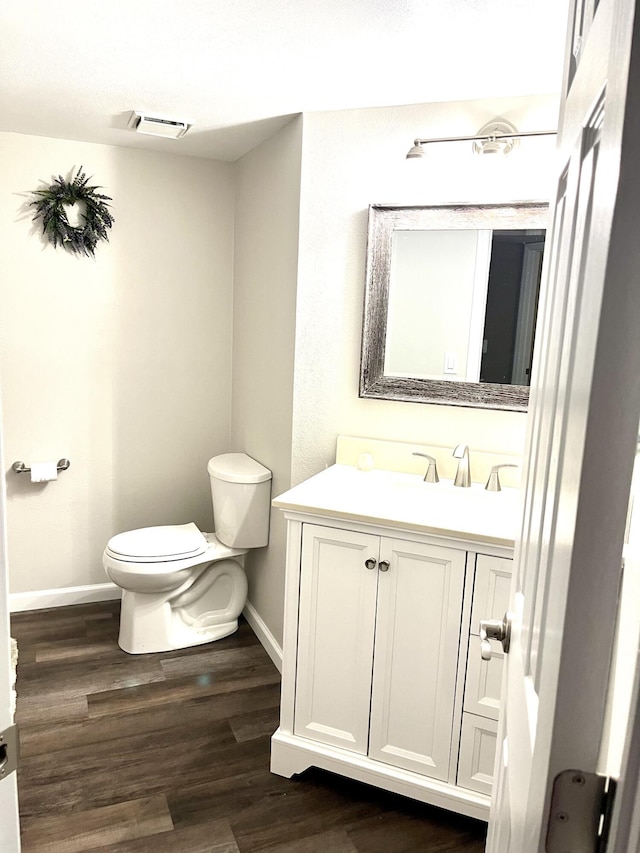 1548 SE Royal Green Cir Unit 105, Port Saint Lucie, FL 34952 - bathroom with toilet, vanity, baseboards, and wood finished floors