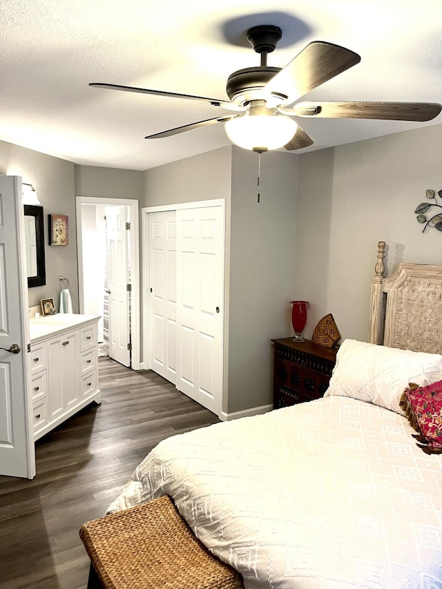 1548 SE Royal Green Cir Unit 105, Port Saint Lucie, FL 34952 - bedroom with dark wood-style flooring, a ceiling fan, connected bathroom, and a closet