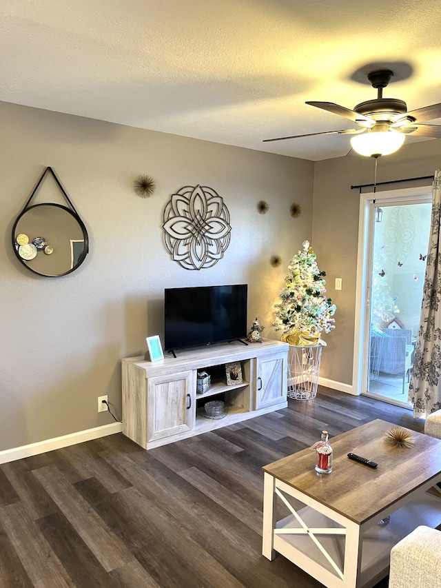 unfurnished living room with dark wood-type flooring, ceiling fan, a textured ceiling, and baseboards