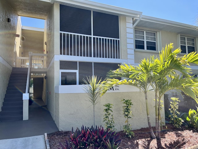 1548 SE Royal Green Cir Unit 105, Port Saint Lucie, FL 34952 - view of side of property with stairway and stucco siding