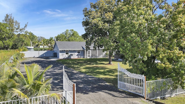 view of road with a gate, driveway, and a gated entry